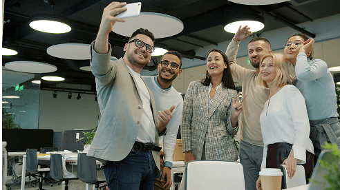Team members taking a selfie in office